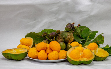 Pequi fruits close-up (Caryocar brasiliense) at various stages of ripening top view . White background