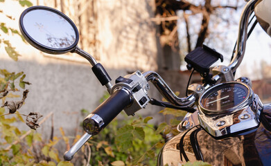 handlebar and speedometer of classic chopper motorcycle close up