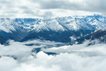 Fototapeta na wymiar Aerial view above the clouds in mountain valley at morning. Wide banner