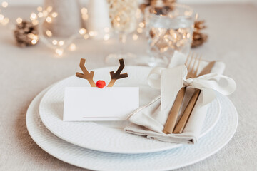 Festive christmas table setting with golden cutlery and porcelain plate and christmas decoration....