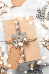 Top view on Christmas gift box wrapped in craft paper. Holidays concept.