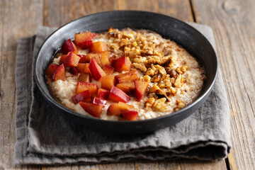 Porridge with plums walnuts and cinnamon