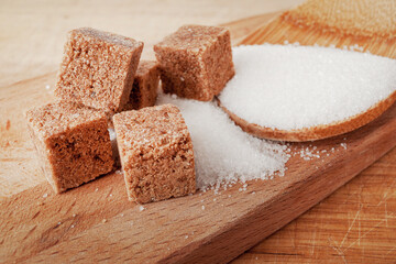 Two types of sugar brown cane and white sugar beet, in cubes and loose, close-up