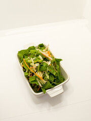 Several vegetables served on a tray in white background