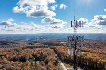Aerial view of mobile phone cell tower over forested rural area of West Virginia to illustrate lack...