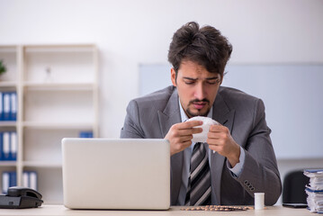 Young businessman employee suffering at workplace