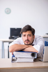 Young male employee working in the office