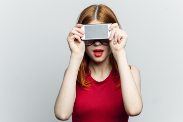 Fototapeta premium pretty woman in glasses with phone in hands communication technology