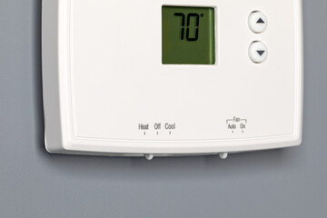 Thermostat for home furnace and air conditioner. Utility bill savings, energy cost and conservation concept
