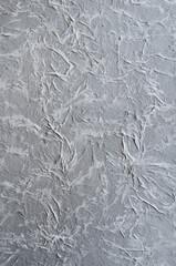 Decorative plaster on wall, textured background close up