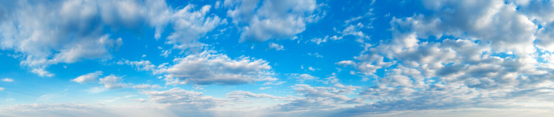 Naklejka na ściany i meble Blue Sky background with tiny Clouds. Panorama background