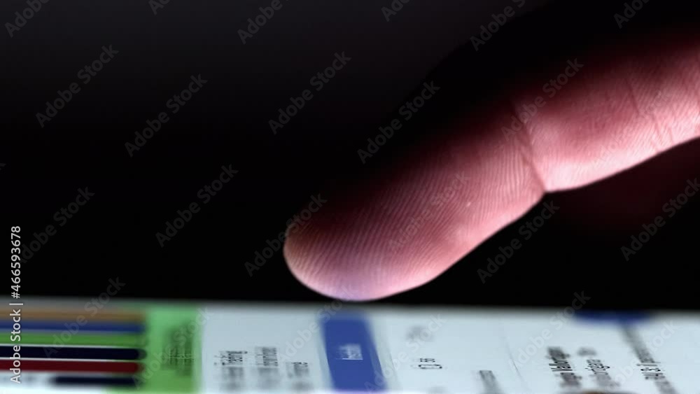 Poster scrolling news on smartphone with single finger. touchscreen with backlight on user's finger.