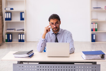 Young male employee working in the office