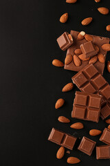Chocolate with almonds and cinnamon on a dark background, Copy space