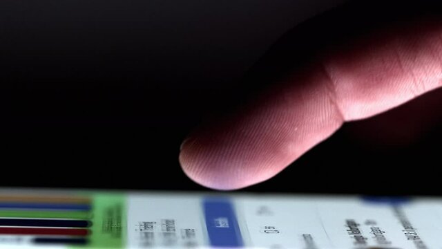Scrolling news on smartphone with single finger. Touchscreen with backlight on user's finger.