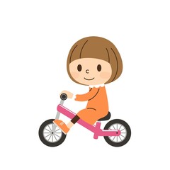 Fototapeta na wymiar キックバイクに乗る女の子ヘルメットなし