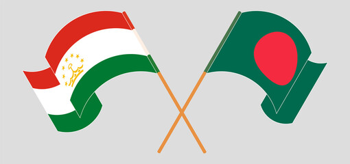 Crossed and waving flags of Tajikistan and Bangladesh