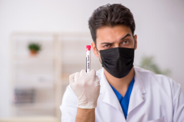 Fototapeta na wymiar Young male biochemist testing blood samples