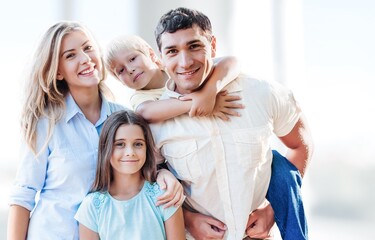 Portraif Of Happy Parents Posing With Their Little children At Home