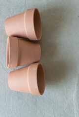 three terracotta pots on their side