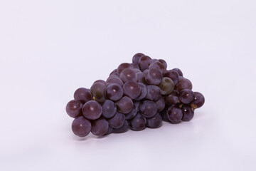 A bunch of pink Niagara grapes on a white background