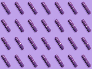 Many tampons on violet background, flat lay