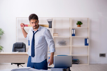 Young male employee unhappy with excessive work in the office