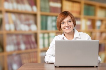 Young girl college student using laptop computer writing