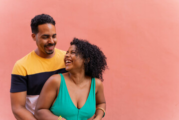 Afro Latin couple loving each other with colored background