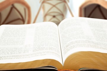 A Jewish Torah textbook on a Synagogue indoor background.