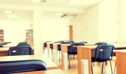 A high school hall or room. examination paper sitting on the edge of a desk or table.