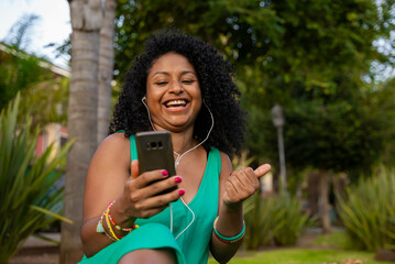 afro latina woman with headphones and mobile