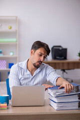 Young male employee working in the office