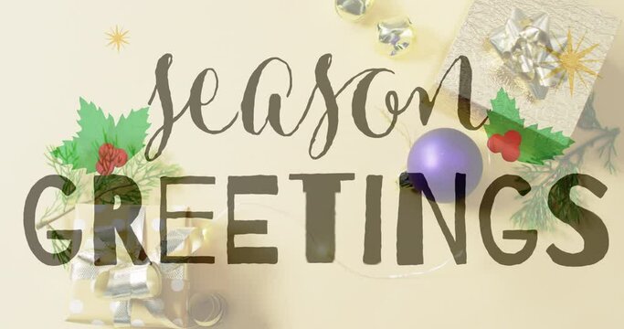 Animation of seasons greetings text over christmas decorations