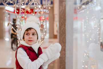 Cute little school kid boy on Christmas market. Holidays, christmas, childhood and people concept.