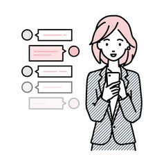 立ってスマートフォンで楽しくチャットで会話するスーツの女性