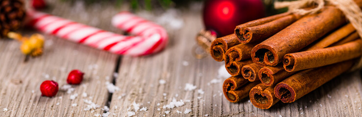 Christmas Holidays Composition Cinnamon and Christmas Decoration on Wooden Background. New Year Concept and Christmas banner. Selective focus.
