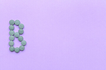 Vitamin B pills on color background