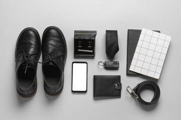 Set of stylish male accessories on grey background