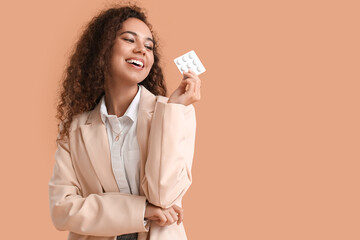 Happy African-American woman with chewing gum on color background