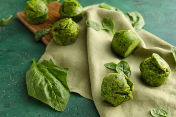 Tasty spinach muffins on color background