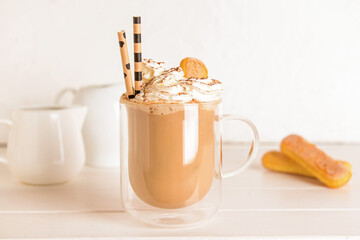 Glass of tasty Tiramisu Latte on table