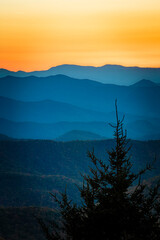 Colorful sky of a setting sun above the ridges of the Blue Ridge mountains in fall © Jo