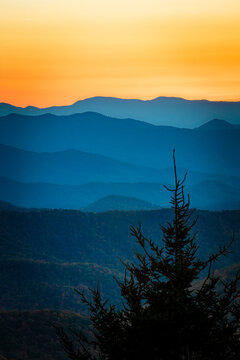 Colorful sky of a setting sun above the ridges of the Blue Ridge mountains in fall