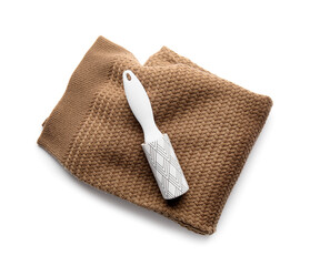 Lint roller with knitted clothes on white background