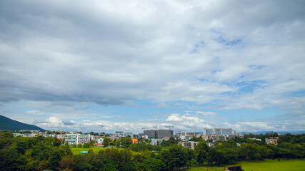 Construction site with yellow lifting crane and blue sky background.