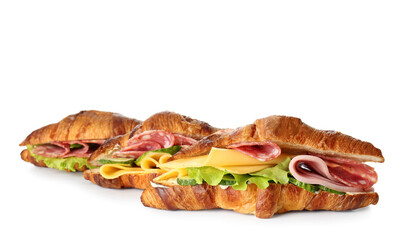 Delicious croissant sandwiches with meat and cheese on white background