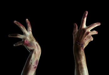 Hands of zombie on dark background