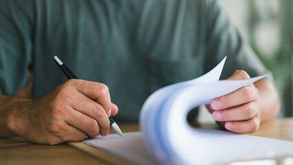 Close up image of person with pen signing contract at desk, Conclusion of agreement with business...