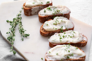 Pieces of fresh bread with lard spread on white background